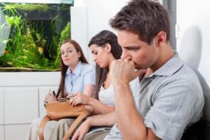 group sitting in a waiting room looking serious