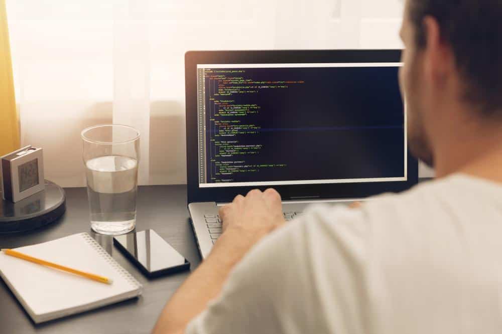man programming on his computer