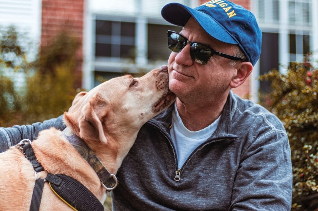 man with therapy dog