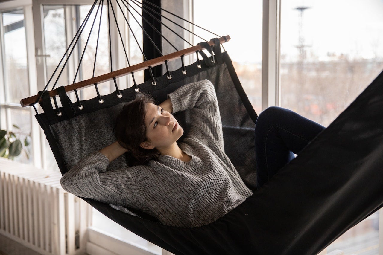 woman on cot practicing mindfulness
